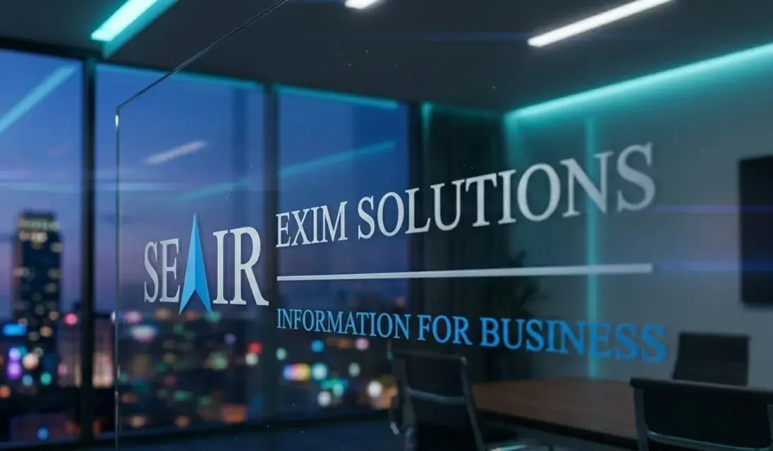 The Seair Exim Solutions logo and its “Information for Business” tagline on a glass meeting-room partition, with a city skyline lit at dusk behind it.